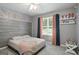 Charming bedroom with a floral wall and large window at 8340 Highway 54, Sharpsburg, GA 30277