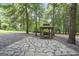 Picturesque gazebo with stone flooring, nestled among towering trees, providing a serene outdoor retreat at 8340 Highway 54, Sharpsburg, GA 30277