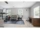 Home gym area with ample natural light, complete with exercise equipment and a desk, ideal for fitness and work at 8340 Highway 54, Sharpsburg, GA 30277