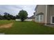 Expansive backyard featuring a well-manicured lawn and a white privacy fence at 705 Mustang Ct, Hampton, GA 30228