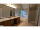 Bathroom featuring double sinks, a large soaking tub, and a glass-enclosed shower at 705 Mustang Ct, Hampton, GA 30228