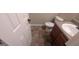 Half bathroom featuring tile floors, vanity with sink and toilet at 705 Mustang Ct, Hampton, GA 30228
