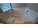 Close-up of a large, modern bathtub with white tile surround, perfect for relaxing at 705 Mustang Ct, Hampton, GA 30228
