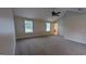 Spacious bedroom with neutral walls and ceiling fan and windows at 705 Mustang Ct, Hampton, GA 30228