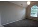 Cozy bedroom with a vaulted ceiling, a large window, and neutral carpet at 705 Mustang Ct, Hampton, GA 30228