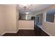 Open dining area featuring dark wood floors and a stylish chandelier at 705 Mustang Ct, Hampton, GA 30228
