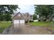 Inviting two-story brick home featuring a two-car garage and a well-maintained lawn at 705 Mustang Ct, Hampton, GA 30228