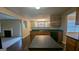 Open concept kitchen with an island and dark countertops flowing into the dining room at 705 Mustang Ct, Hampton, GA 30228