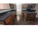 This kitchen features dark countertops, wood cabinets, and a gas stove cooktop at 705 Mustang Ct, Hampton, GA 30228