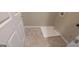 Functional laundry room with durable tile flooring and a convenient floor drain at 705 Mustang Ct, Hampton, GA 30228