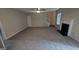 Spacious living room with fireplace, ceiling fan and stairs in the background at 705 Mustang Ct, Hampton, GA 30228