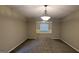 Spacious living room with carpet and a stylish chandelier at 705 Mustang Ct, Hampton, GA 30228