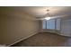 Cozy living room with neutral carpet and a decorative chandelier at 705 Mustang Ct, Hampton, GA 30228