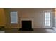 Cozy living room featuring a fireplace and glass panel exterior door at 705 Mustang Ct, Hampton, GA 30228