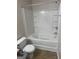 Bathroom featuring a toilet and tub shower combo with white walls at 755 Magnolia Gardens Walk, Mcdonough, GA 30253