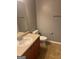Neutral bathroom featuring a single sink vanity, toilet, and tile flooring at 755 Magnolia Gardens Walk, Mcdonough, GA 30253