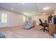 Basement area featuring neutral carpet, a gray recliner, recessed lighting, and an exterior door at 301 East Highway 5, Roopville, GA 30170