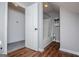 Bathroom featuring hardwood flooring, a walk-in shower with white fixtures, and neutral wall paint at 301 East Highway 5, Roopville, GA 30170