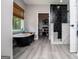 Inviting bathroom with a freestanding tub and a modern shower, offering a luxurious experience at 301 East Highway 5, Roopville, GA 30170