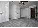 Spacious bedroom showing carpet, a ceiling fan, white doors and a glimpse into another room at 301 East Highway 5, Roopville, GA 30170