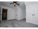 Bright bedroom with a neutral color palette, ceiling fan, carpet and a view into an adjoining space at 301 East Highway 5, Roopville, GA 30170