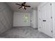 Bedroom with ceiling fan, light gray walls, gray carpeting, and a unique geometric trim wall at 301 East Highway 5, Roopville, GA 30170