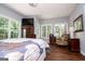 Bright bedroom with a ceiling fan and large windows offering a relaxing atmosphere at 301 East Highway 5, Roopville, GA 30170