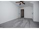 Neutral bedroom featuring a carpet, a ceiling fan, light-colored walls, and several doors at 301 East Highway 5, Roopville, GA 30170