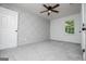 Bright bedroom with a ceiling fan, gray carpet, and a stylish wall with geometric trim at 301 East Highway 5, Roopville, GA 30170