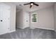 Bedroom with a light gray color scheme, ceiling fan, window with view, and gray carpeting at 301 East Highway 5, Roopville, GA 30170