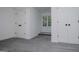 Bedroom showcasing gray carpeting, three white doors with black hardware and a window at 301 East Highway 5, Roopville, GA 30170