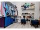 Organized walk-in closet featuring white wire shelving for clothes, shoes and storage; also includes blue accent seating at 301 East Highway 5, Roopville, GA 30170