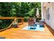 Relax on this lovely back deck with an outdoor seating area and beautiful plants at 301 East Highway 5, Roopville, GA 30170