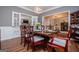 Spacious dining room featuring hardwood floors, a modern chandelier, and French doors to an adjacent room at 301 East Highway 5, Roopville, GA 30170