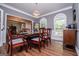Elegant dining room with hardwood floors, modern chandelier, and natural light from large windows at 301 East Highway 5, Roopville, GA 30170