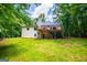 Exterior home view featuring large deck, stairs and yard at 301 East Highway 5, Roopville, GA 30170
