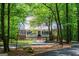 Home with brick accents and a covered porch is partially visible through the trees at 301 East Highway 5, Roopville, GA 30170