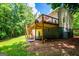 View of back deck, stairs and home exterior with trees in background at 301 East Highway 5, Roopville, GA 30170