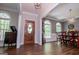 Inviting foyer with hardwood floors, arched windows, and a view into the dining area, creating an open and elegant entrance at 301 East Highway 5, Roopville, GA 30170
