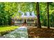 Beautiful home featuring a welcoming front porch, dormer windows, and brick accents in a wooded setting at 301 East Highway 5, Roopville, GA 30170