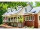 Stylish home featuring brick accents, white siding, a metal roof, and a welcoming front porch at 301 East Highway 5, Roopville, GA 30170