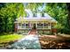 Eye-catching home with a metal roof, inviting front porch, brick accents, and a perfectly manicured lawn at 301 East Highway 5, Roopville, GA 30170