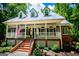 Beautiful home with a charming front porch, brick accents, and dormer windows, offering great curb appeal at 301 East Highway 5, Roopville, GA 30170