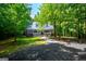 Charming brick and wood home with a metal roof, inviting front porch, and lush surroundings at 301 East Highway 5, Roopville, GA 30170