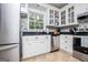 Well-lit kitchen features white cabinets, granite countertops, stainless appliances, and a stylish backsplash at 301 East Highway 5, Roopville, GA 30170