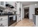 Updated kitchen with white cabinets, stainless steel appliances, and tile backsplash at 301 East Highway 5, Roopville, GA 30170