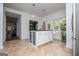 Bright kitchen with a central island, white cabinets, and tile flooring at 301 East Highway 5, Roopville, GA 30170