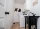 Laundry room with modern washer and dryer, wash basin, and tile floors at 301 East Highway 5, Roopville, GA 30170