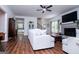 Bright and airy living room with hardwood floors, white sofas, and a view of the staircase at 301 East Highway 5, Roopville, GA 30170
