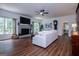 Bright living room with a brick fireplace, ceiling fan, and hardwood floors at 301 East Highway 5, Roopville, GA 30170